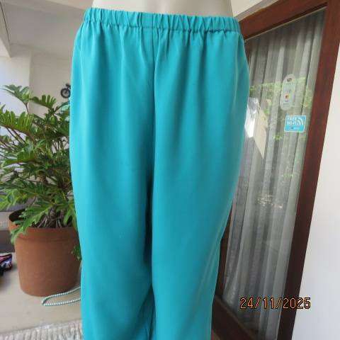 Boutique made aqua colour pants with tapered legs in polyester with elasticated waist. Size 40