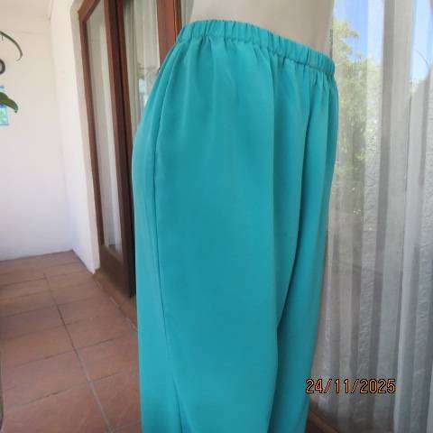 Boutique made aqua colour pants with tapered legs in polyester with elasticated waist. Size 40