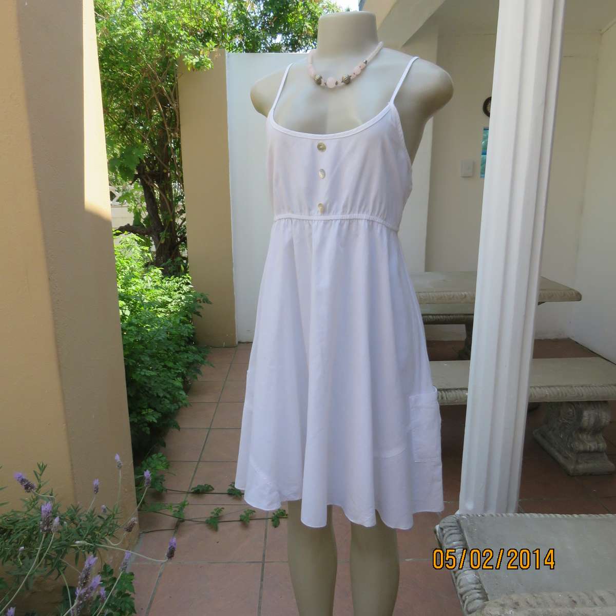 As new white slightly creased 100% cotton strappy dress. Size 36.Elasticated waist.Half flare skirt.
