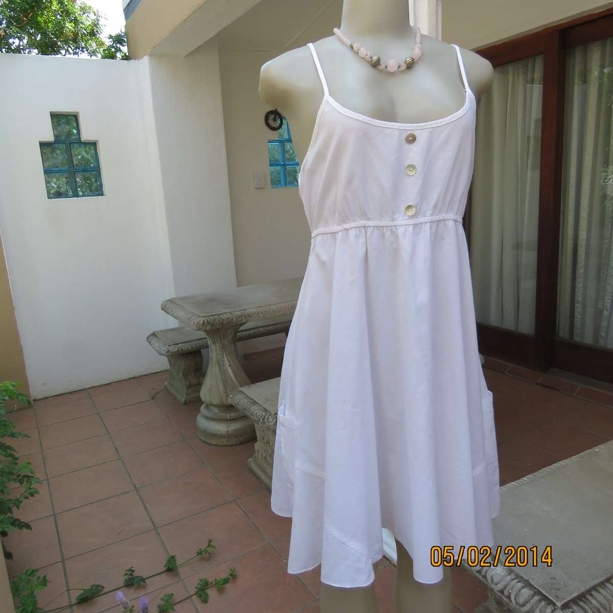 As new white slightly creased 100% cotton strappy dress. Size 36.Elasticated waist.Half flare skirt.