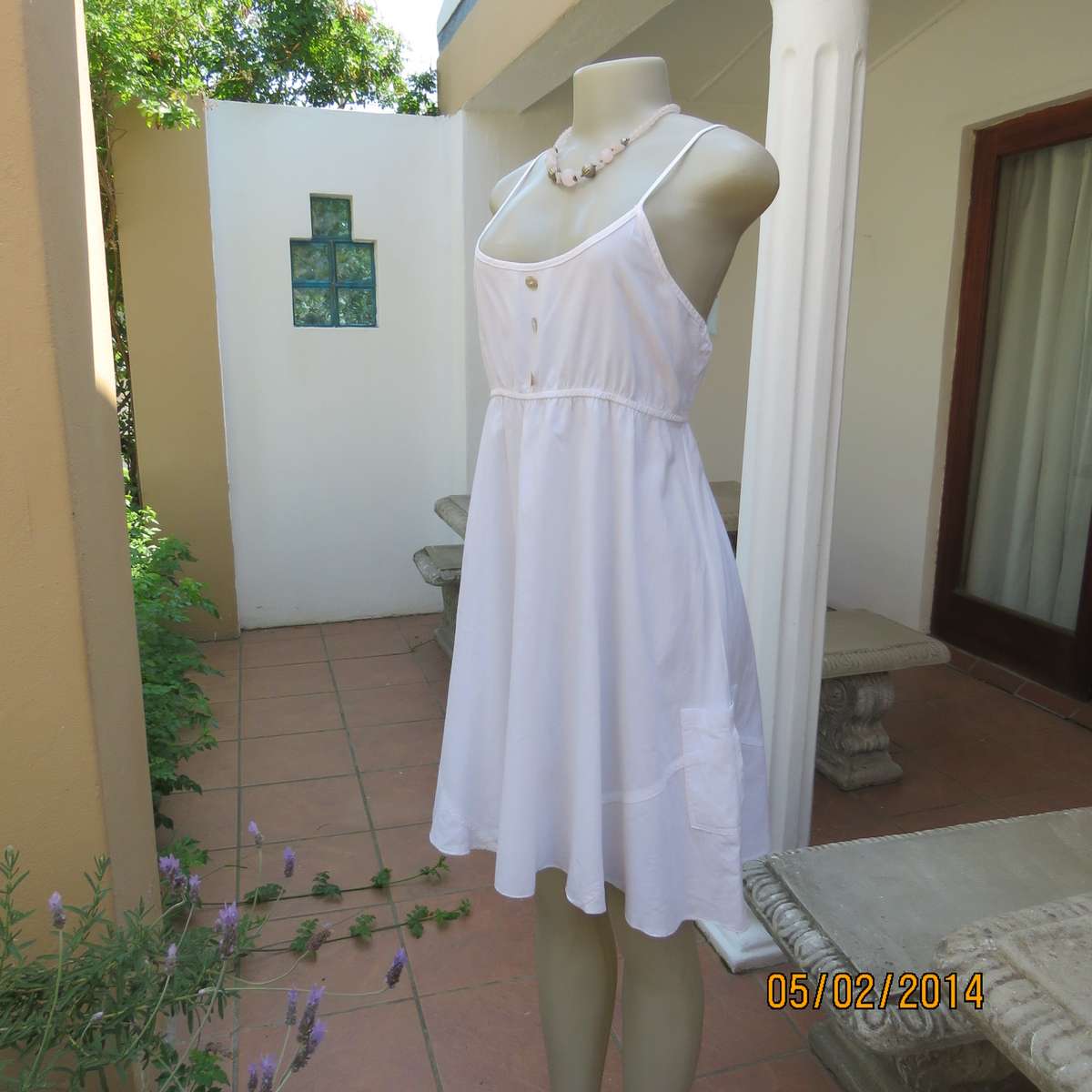 As new white slightly creased 100% cotton strappy dress. Size 36.Elasticated waist.Half flare skirt.