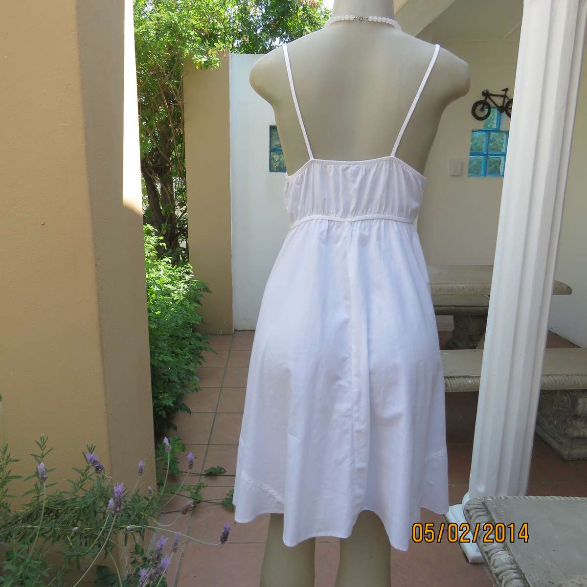 As new white slightly creased 100% cotton strappy dress. Size 36.Elasticated waist.Half flare skirt.