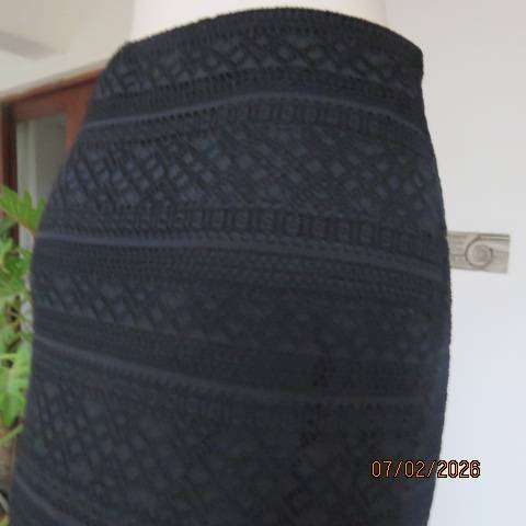 Very black stretch polyester pencil skirt with 2 layers - top layer in stretch lace. Size 40