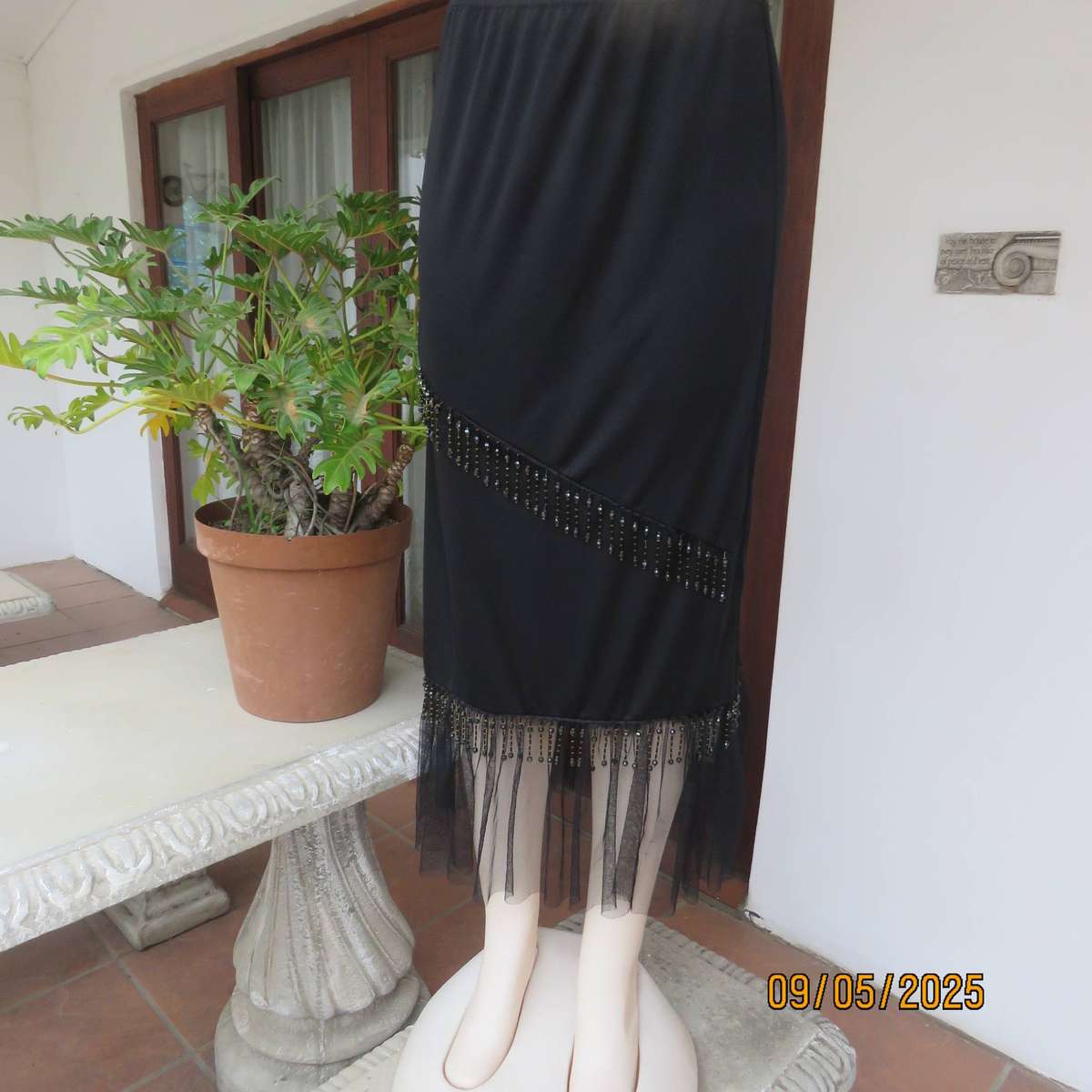 Black stretch polyester ankle length skirt with elastic waist. Netting and beads. Size 36