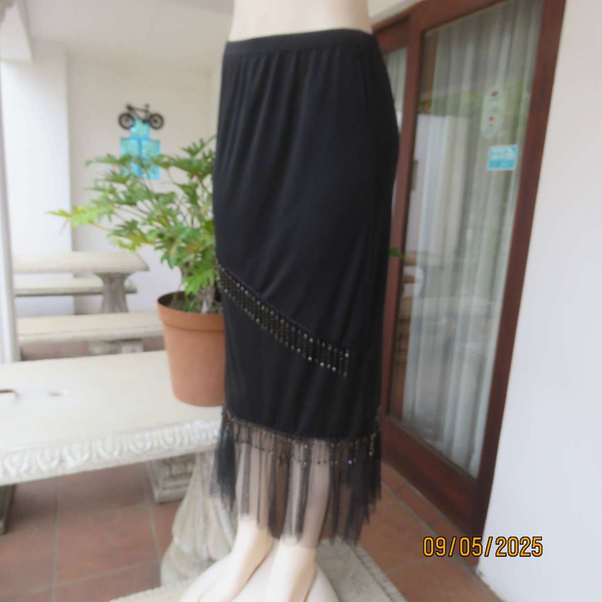 Black stretch polyester ankle length skirt with elastic waist. Netting and beads. Size 36
