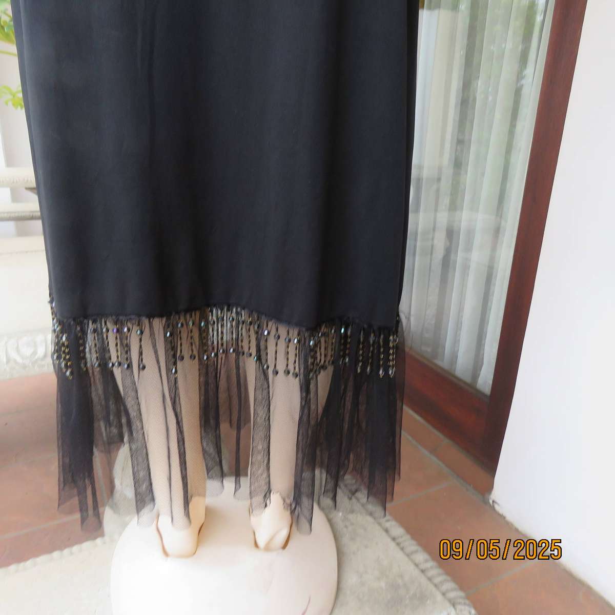 Black stretch polyester ankle length skirt with elastic waist. Netting and beads. Size 36