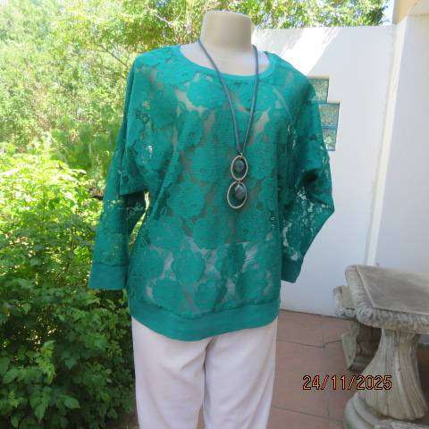 Green jade opaque slip over dolman sleeve top with floral pattern. Size 38