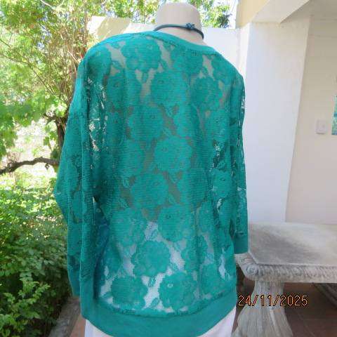Green jade opaque slip over dolman sleeve top with floral pattern. Size 38