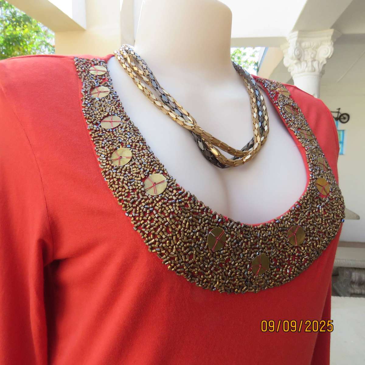 WOOLWORTHS burnt orange stretch viscose top with antique gold neckline embellishment. Size 38