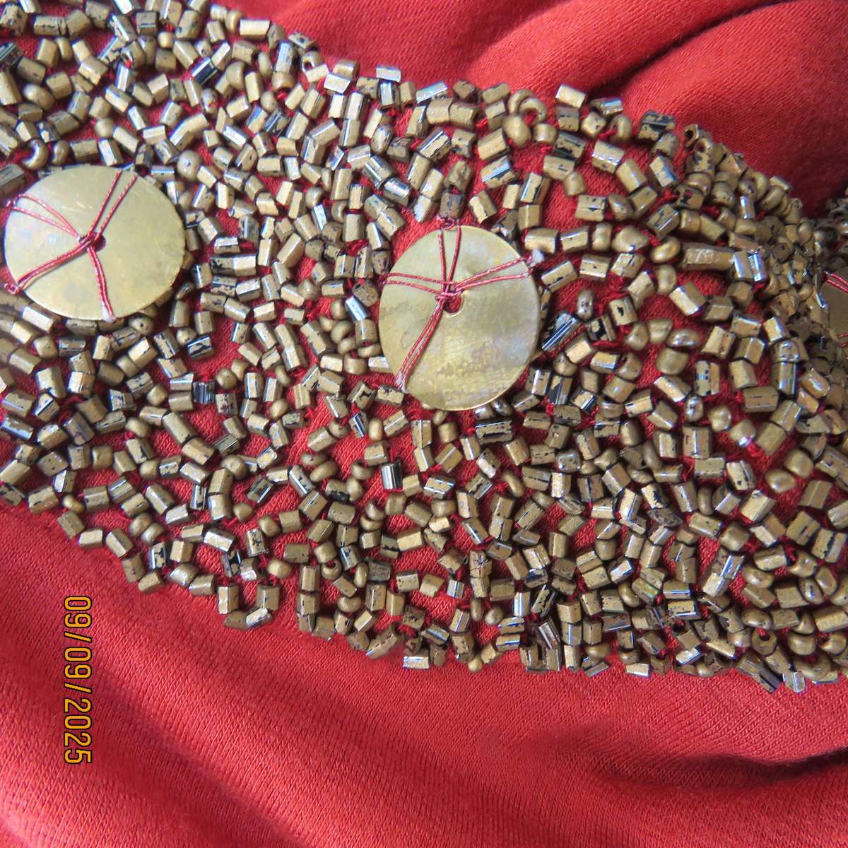 WOOLWORTHS burnt orange stretch viscose top with antique gold neckline embellishment. Size 38