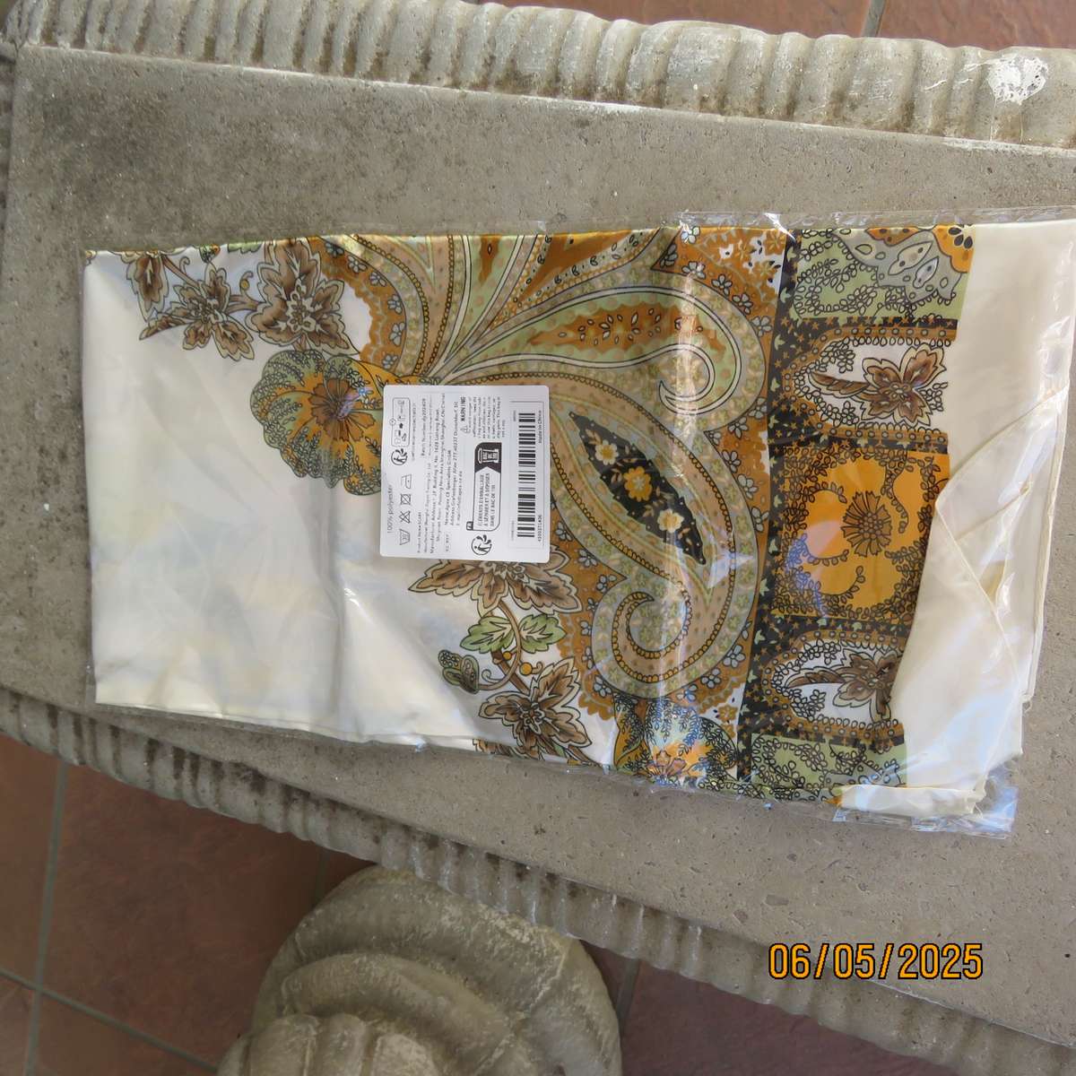 Square 90cm x 90cm cream satin polyester scarf with paisley pattern border in autumn colours.