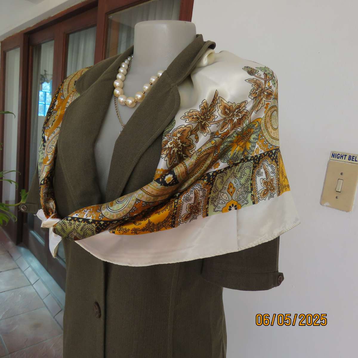 Square 90cm x 90cm cream satin polyester scarf with paisley pattern border in autumn colours.