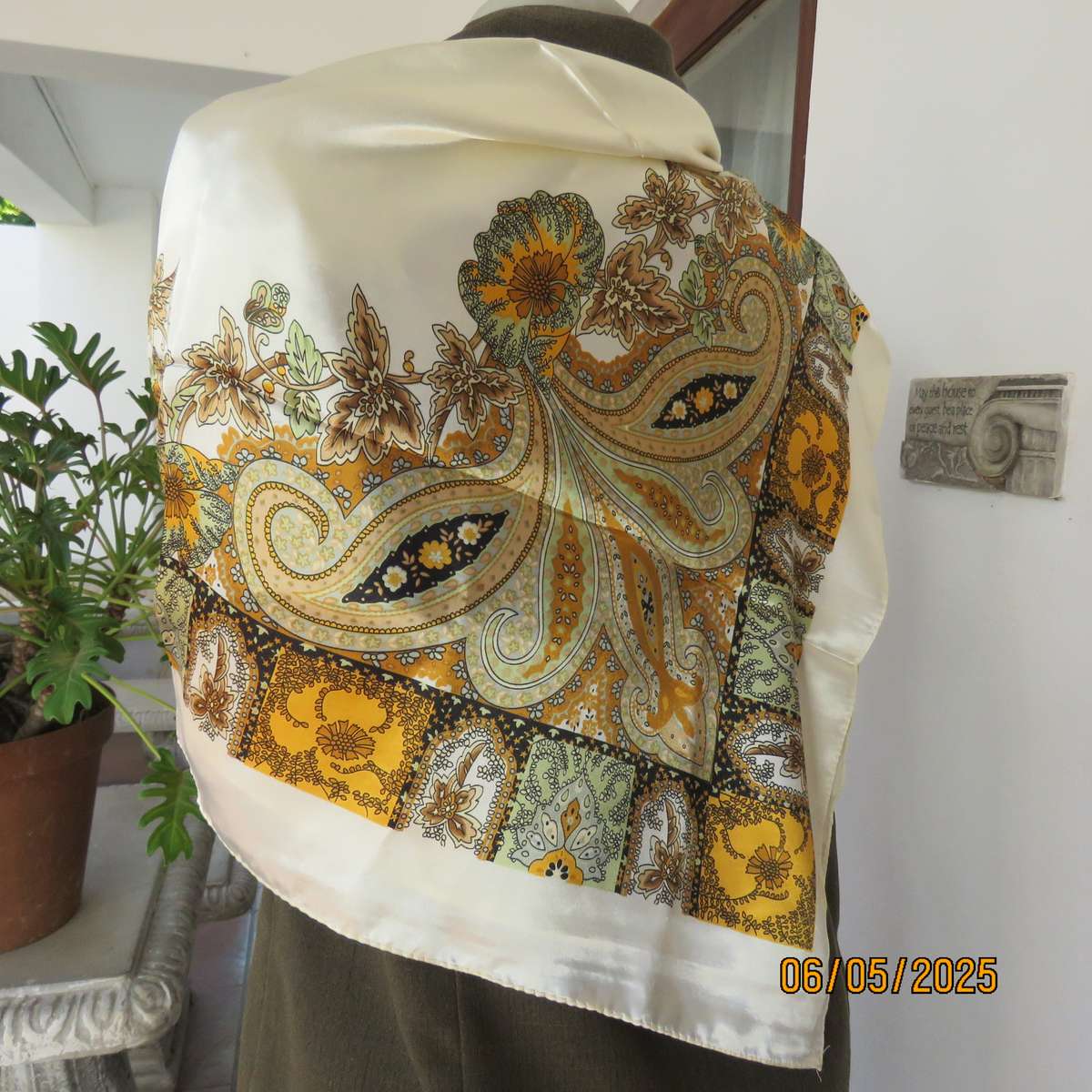 Square 90cm x 90cm cream satin polyester scarf with paisley pattern border in autumn colours.