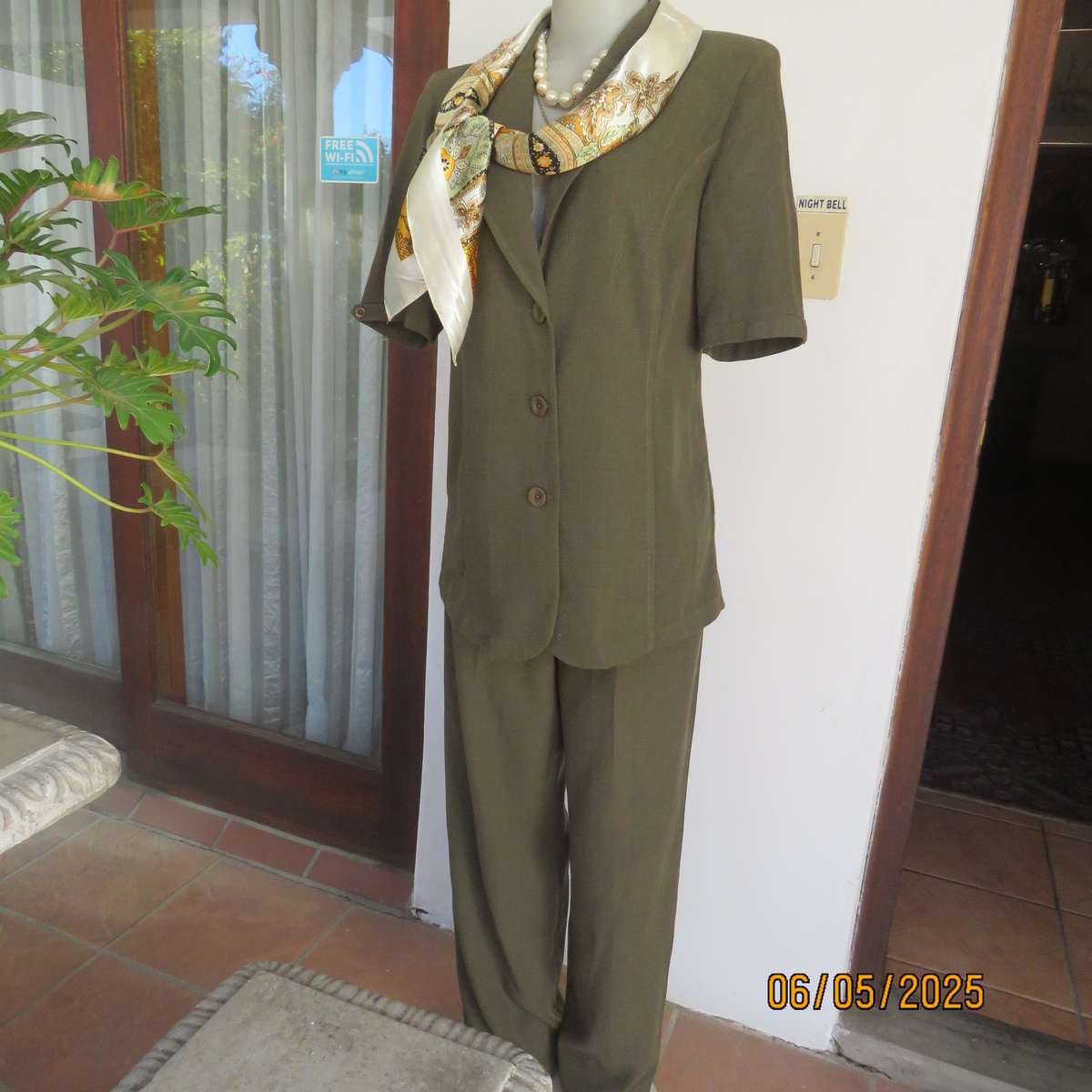 Square 90cm x 90cm cream satin polyester scarf with paisley pattern border in autumn colours.