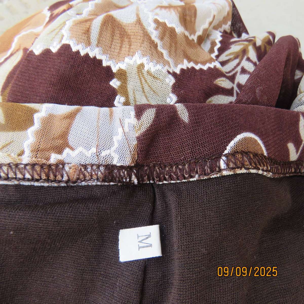 Brown with bold white-beige floral print sheer polyester skirt halfway lined. Size 38