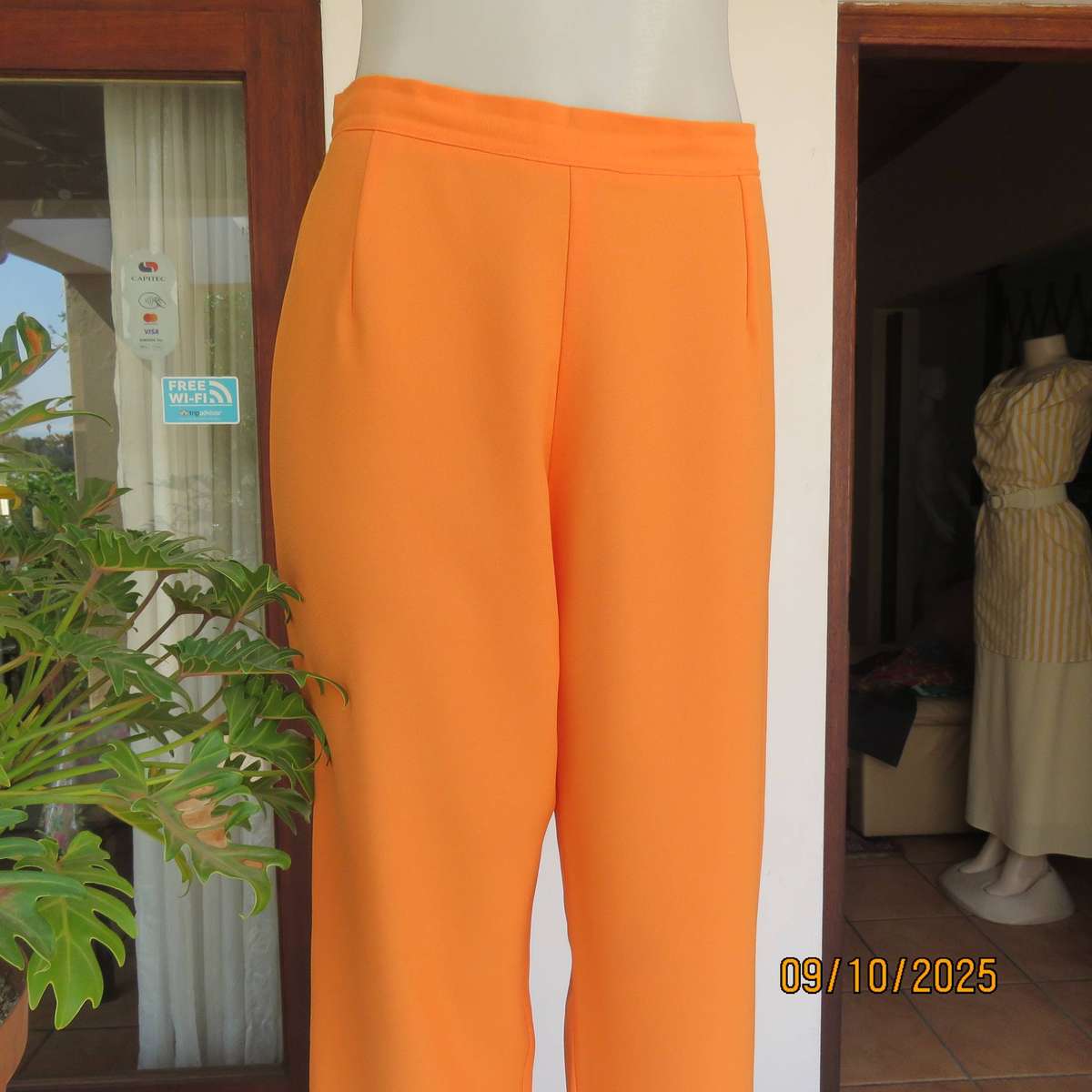 Tangerine orange ankle length textured polyester pants. Side zip. Size 38.