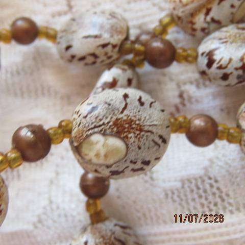 Bohemian handmade necklace with castor beans and brown beads, 78cm length
