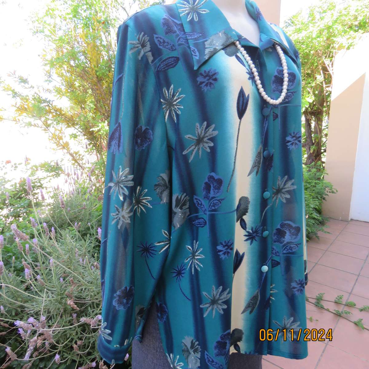 Smart long cuffed sleeve RENE TAYLOR text. polyester top in jade-blue shades.Floral design.Size 42