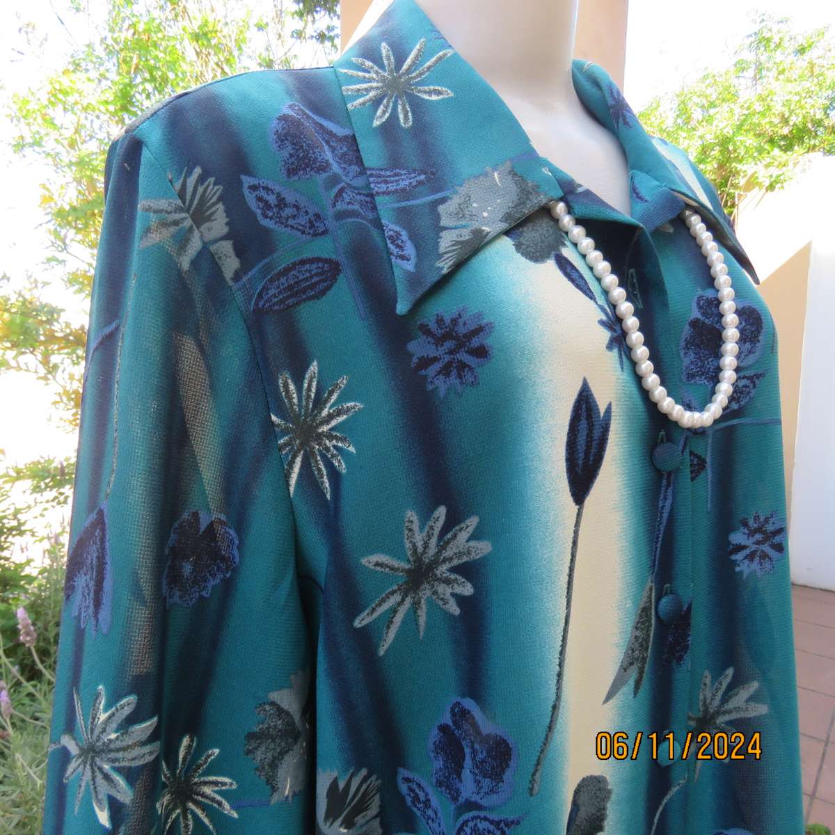 Smart long cuffed sleeve RENE TAYLOR text. polyester top in jade-blue shades.Floral design.Size 42