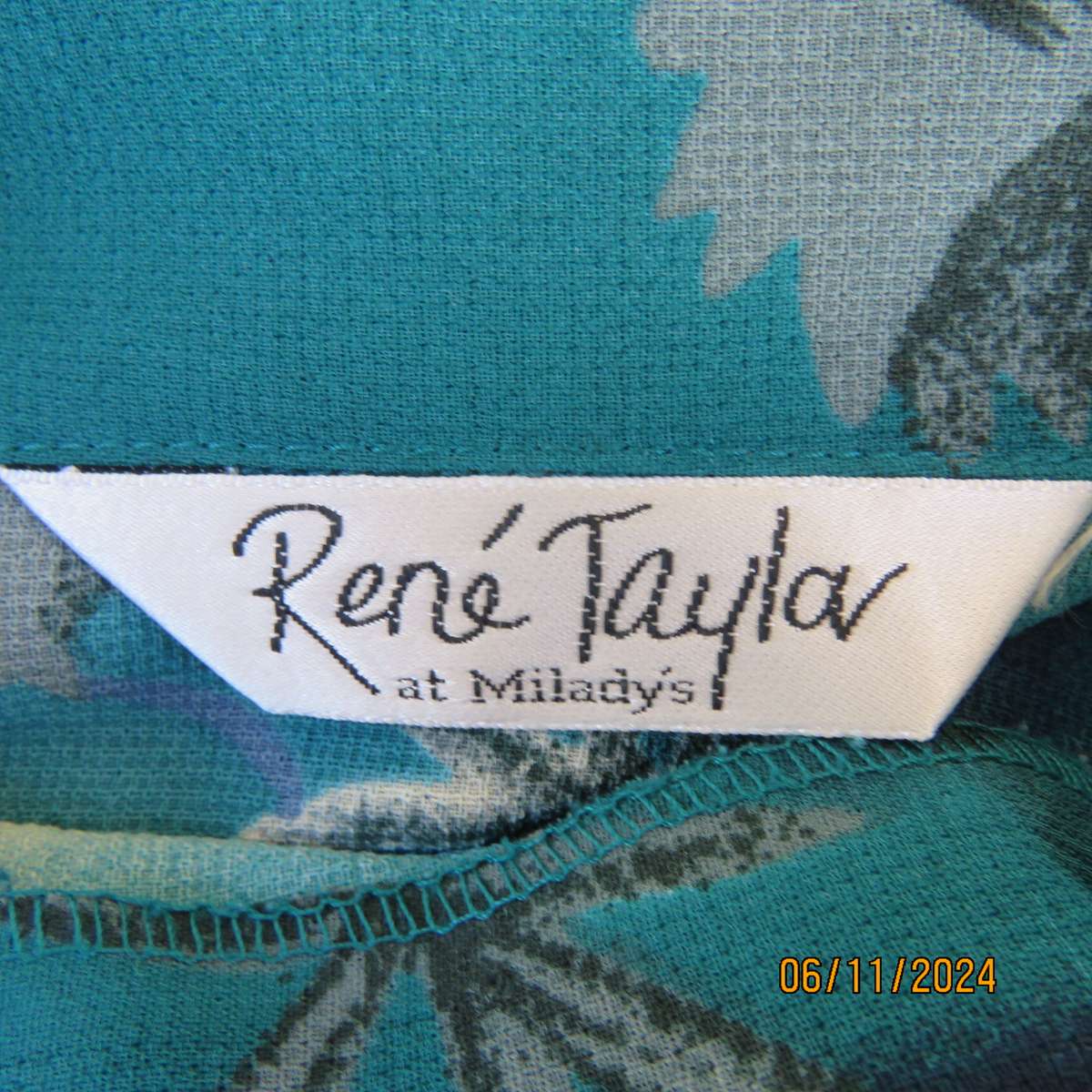 Smart long cuffed sleeve RENE TAYLOR text. polyester top in jade-blue shades.Floral design.Size 42