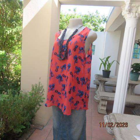 Cool crimson sleeveless slip over top with blue-black floral print in polyester. Size 40-42