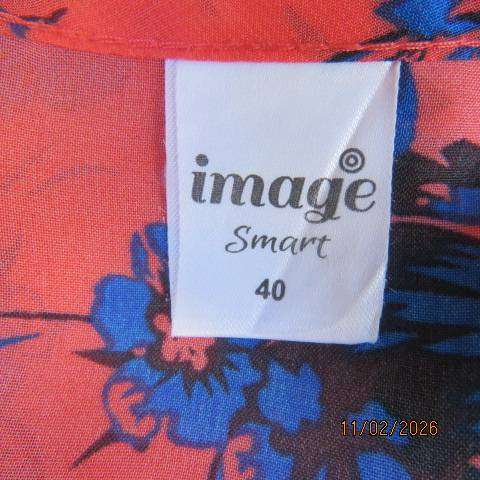 Cool crimson sleeveless slip over top with blue-black floral print in polyester. Size 40-42