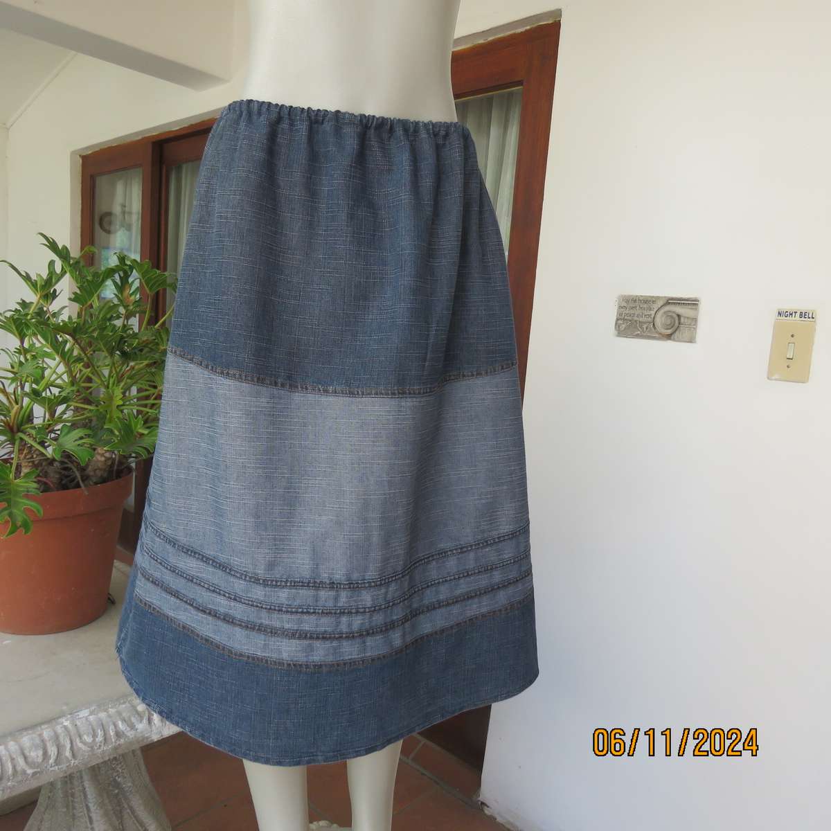 Blue denim skirt in horizontal panels with cord decoration Size 38-40.Polycotton. Elasticated waist.