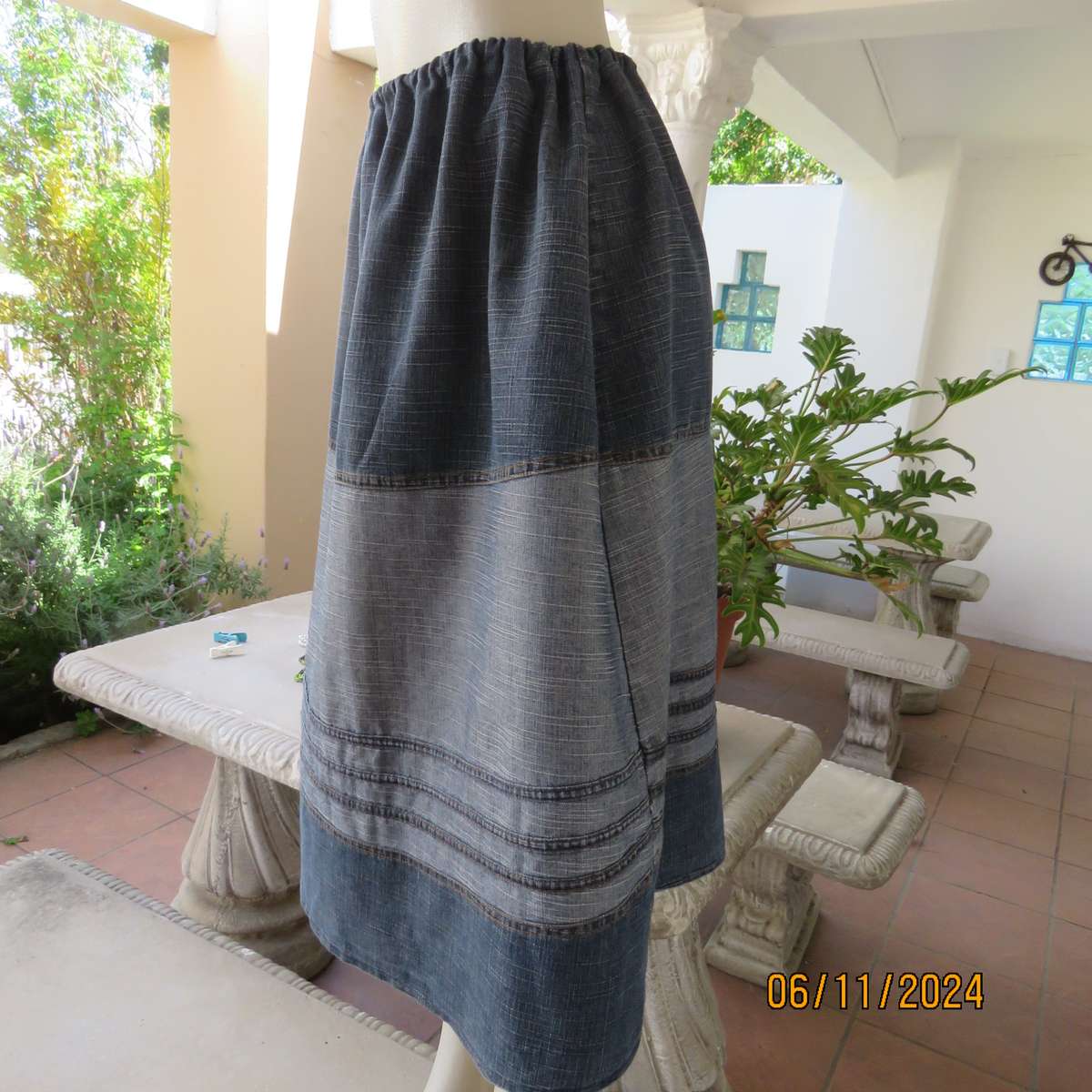 Blue denim skirt in horizontal panels with cord decoration Size 38-40.Polycotton. Elasticated waist.