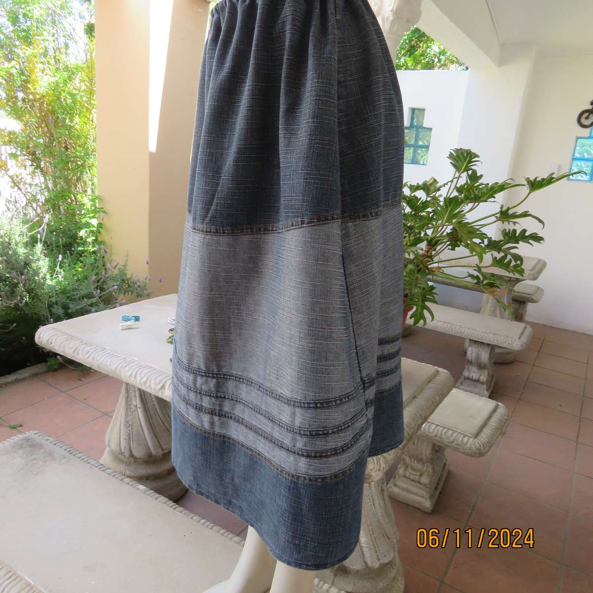 Blue denim skirt in horizontal panels with cord decoration Size 38-40.Polycotton. Elasticated waist.