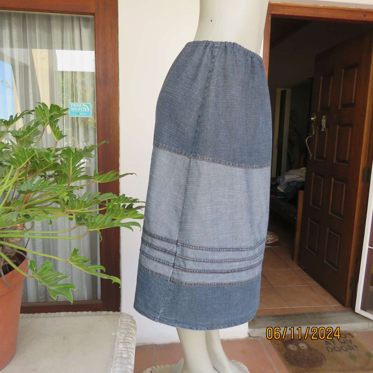 Blue denim skirt in horizontal panels with cord decoration Size 38-40.Polycotton. Elasticated waist.