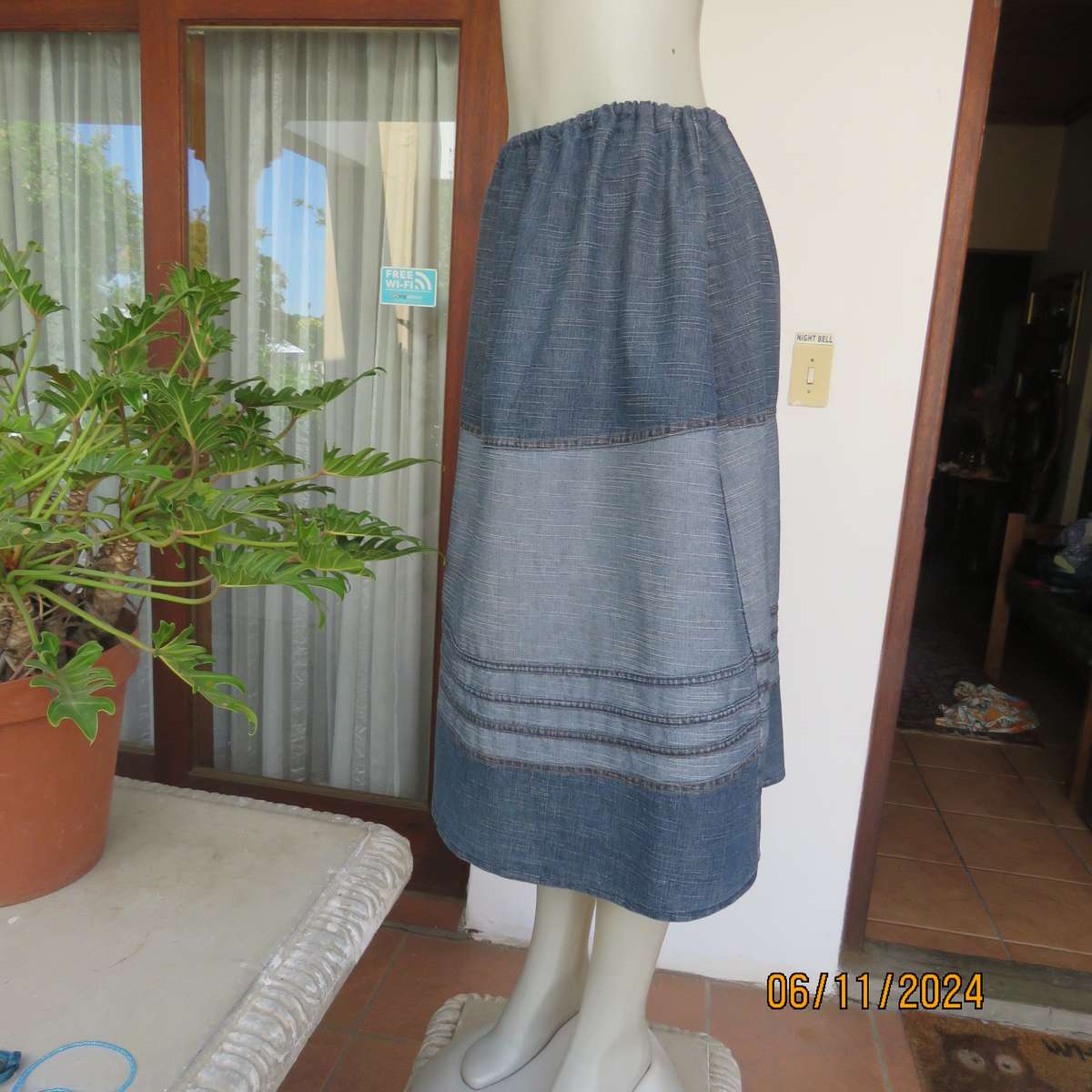 Blue denim skirt in horizontal panels with cord decoration Size 38-40.Polycotton. Elasticated waist.