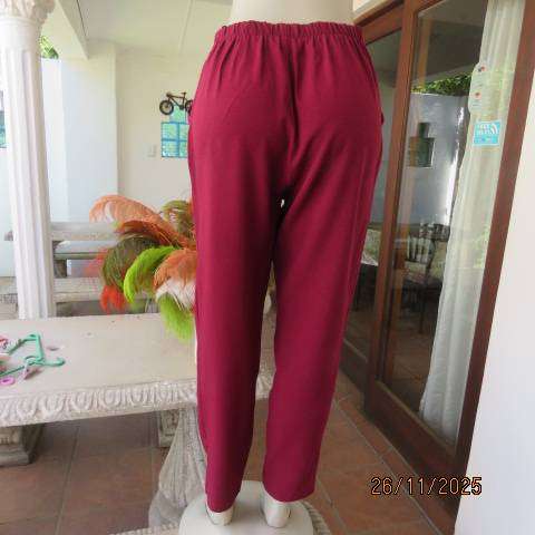 Maroon stretch polyester skinny leg pants. Pleated front-elasticated back. Size 38