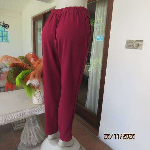 Maroon stretch polyester skinny leg pants. Pleated front-elasticated back. Size 38