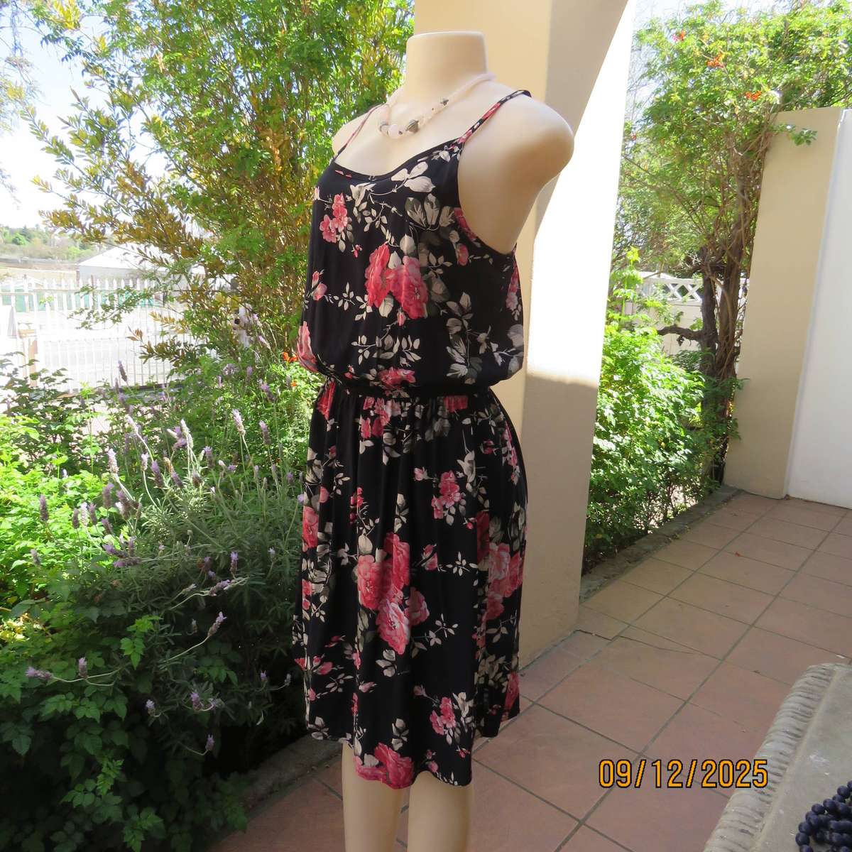 Black 100% rayon strappy dress with bold pink flowers. Size 38