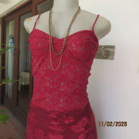 Dark red acrylic stretch strappy top-bustier in a very good condition. Size 34