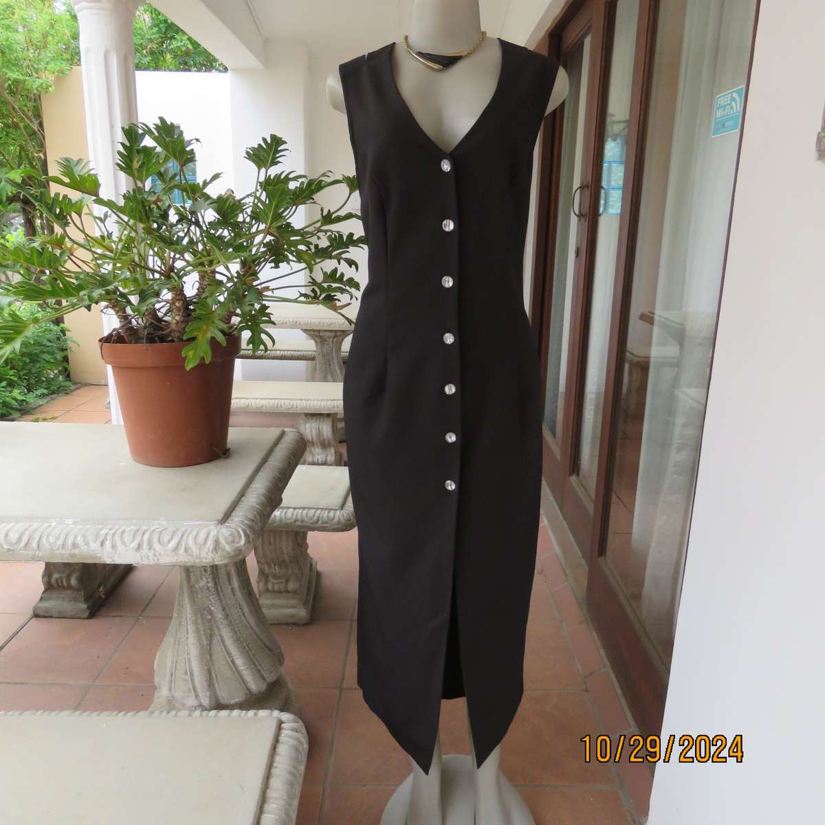 Beautiful black sleek button down ankle length dress by CHARLOTTE size 36. Criss cross strap back.