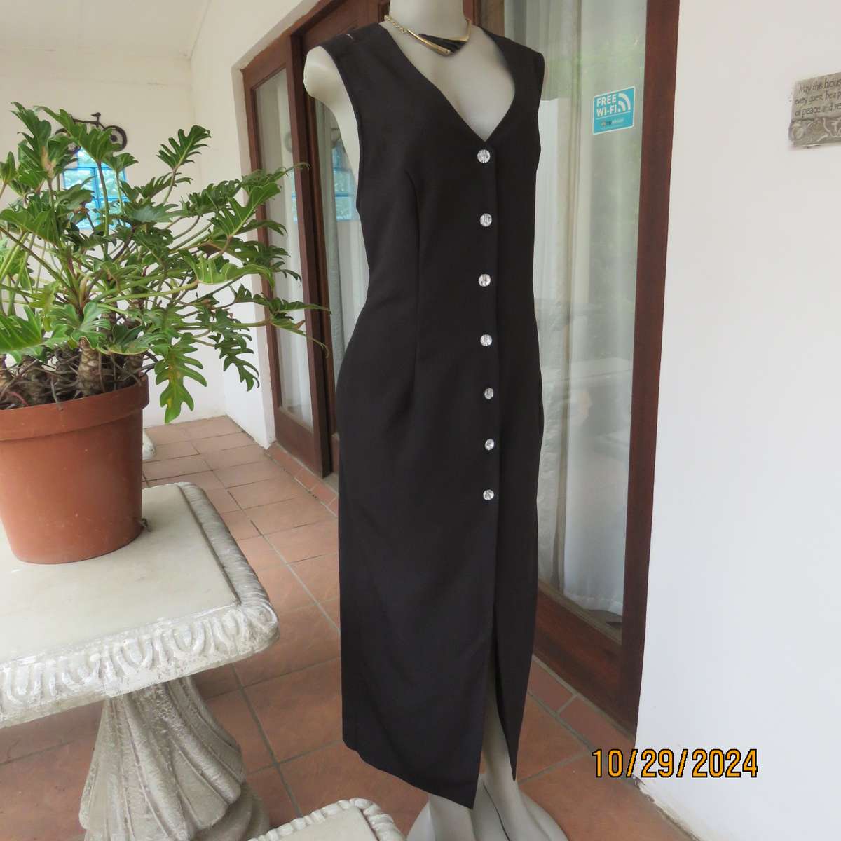 Beautiful black sleek button down ankle length dress by CHARLOTTE size 36. Criss cross strap back.