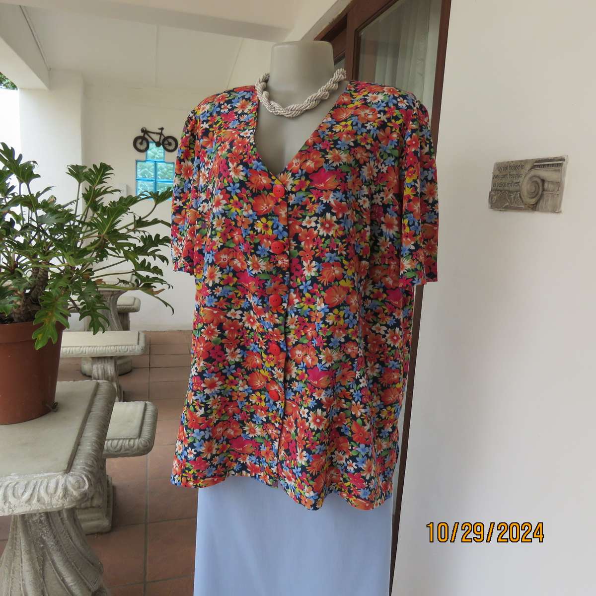 Silky polyester floral top in array of colours. V neck button down. Short sleeves. Size 46. As new