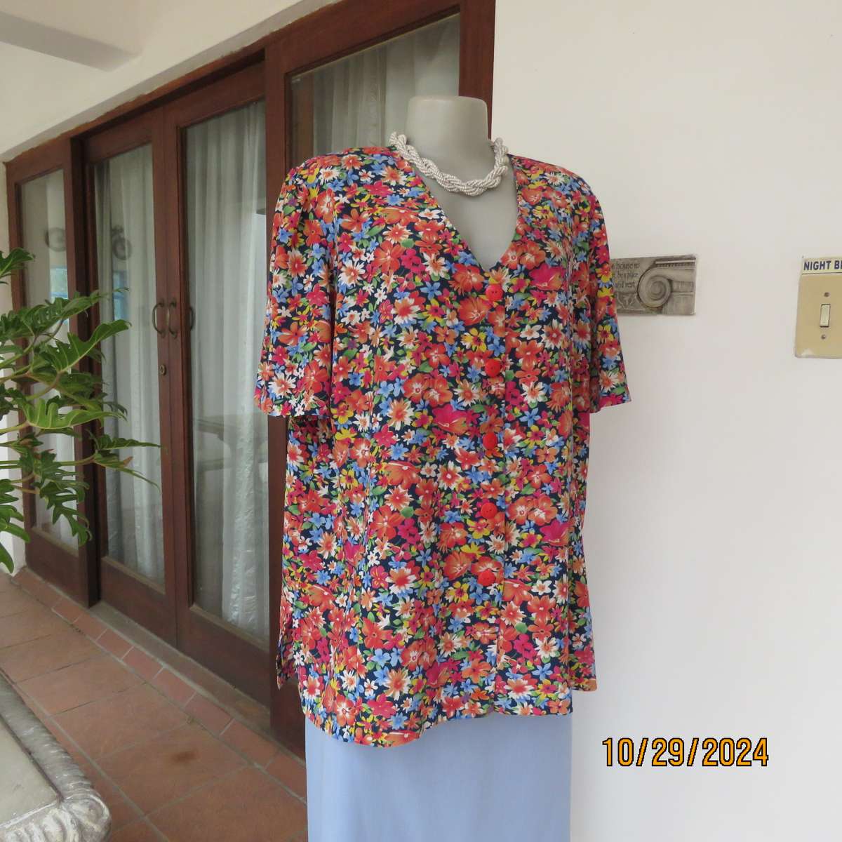 Silky polyester floral top in array of colours. V neck button down. Short sleeves. Size 46. As new