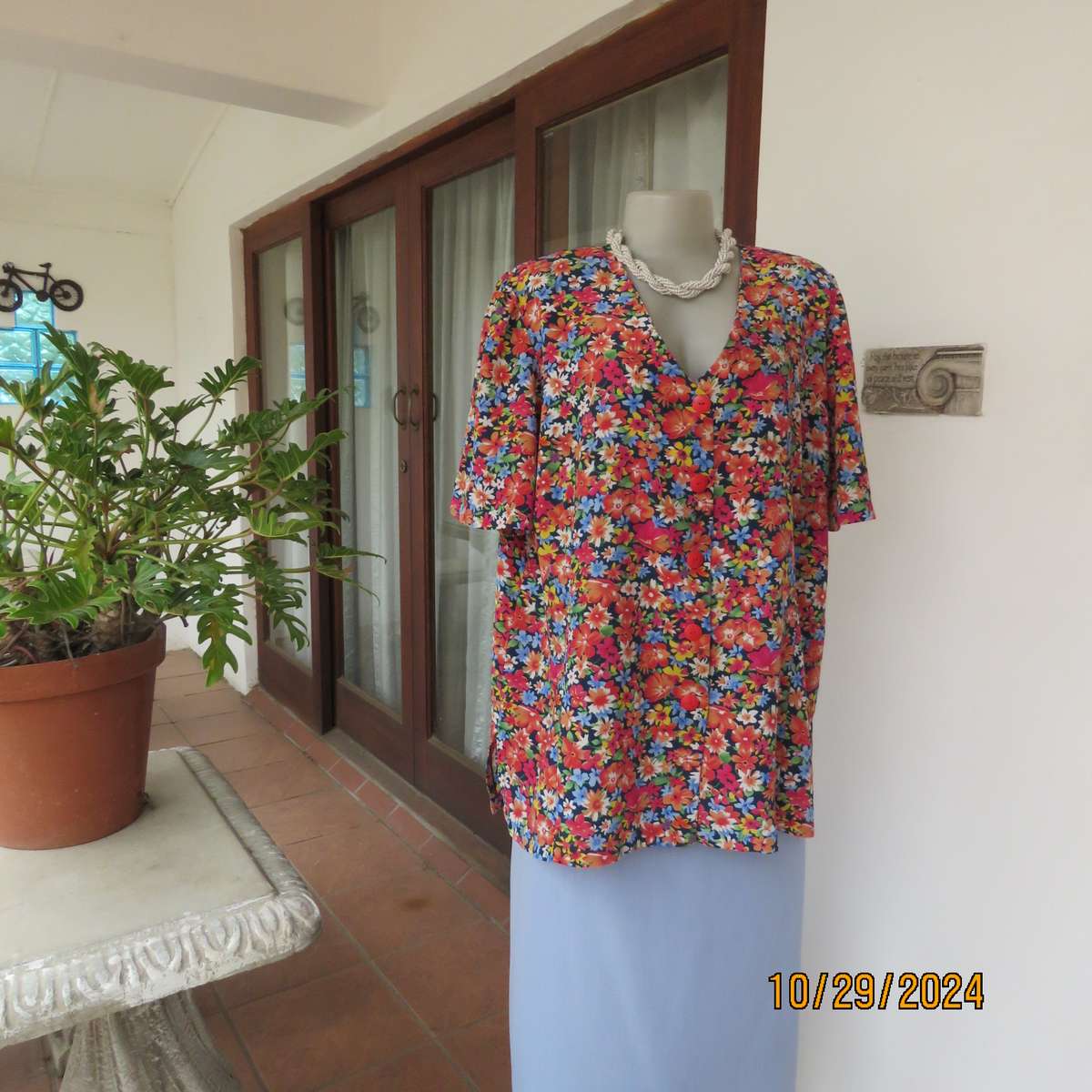 Silky polyester floral top in array of colours. V neck button down. Short sleeves. Size 46. As new