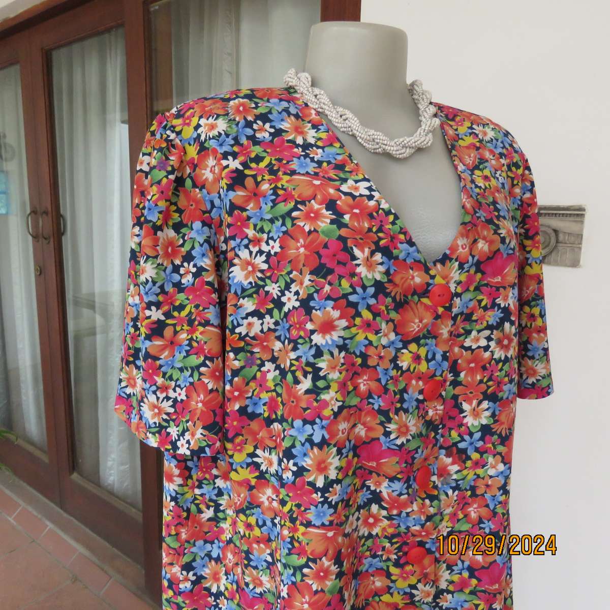 Silky polyester floral top in array of colours. V neck button down. Short sleeves. Size 46. As new