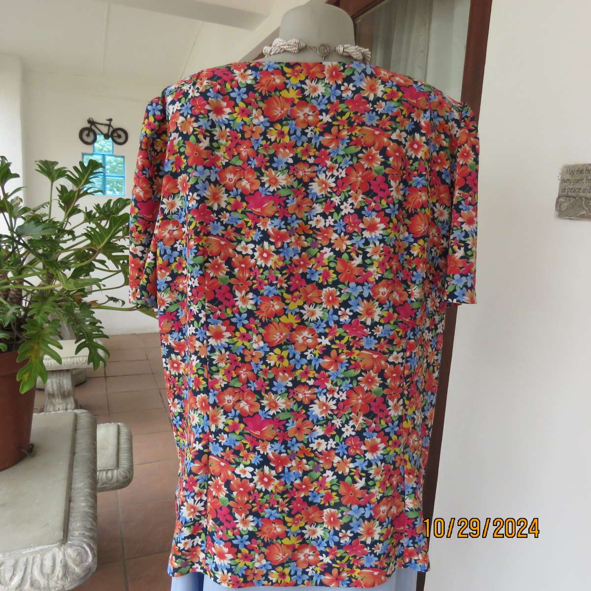 Silky polyester floral top in array of colours. V neck button down. Short sleeves. Size 46. As new