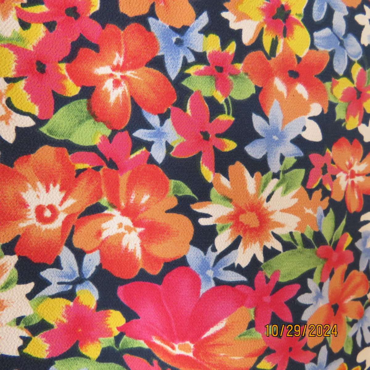 Silky polyester floral top in array of colours. V neck button down. Short sleeves. Size 46. As new