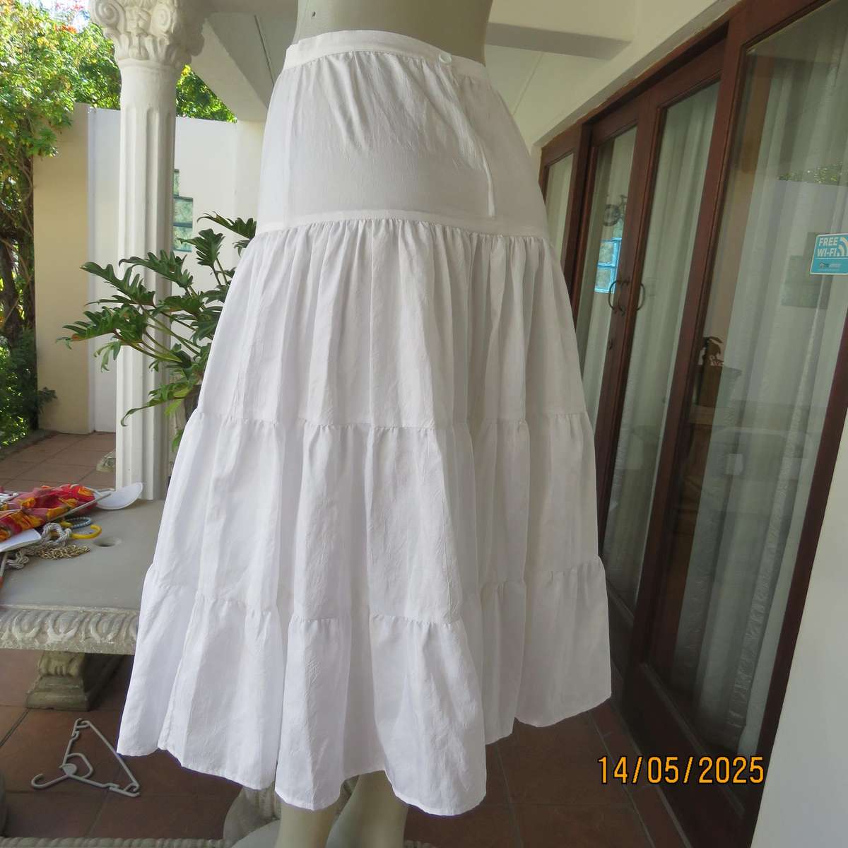Boutique made white creased silky polyester tiered skirt. Underlayer with netting.Size 34