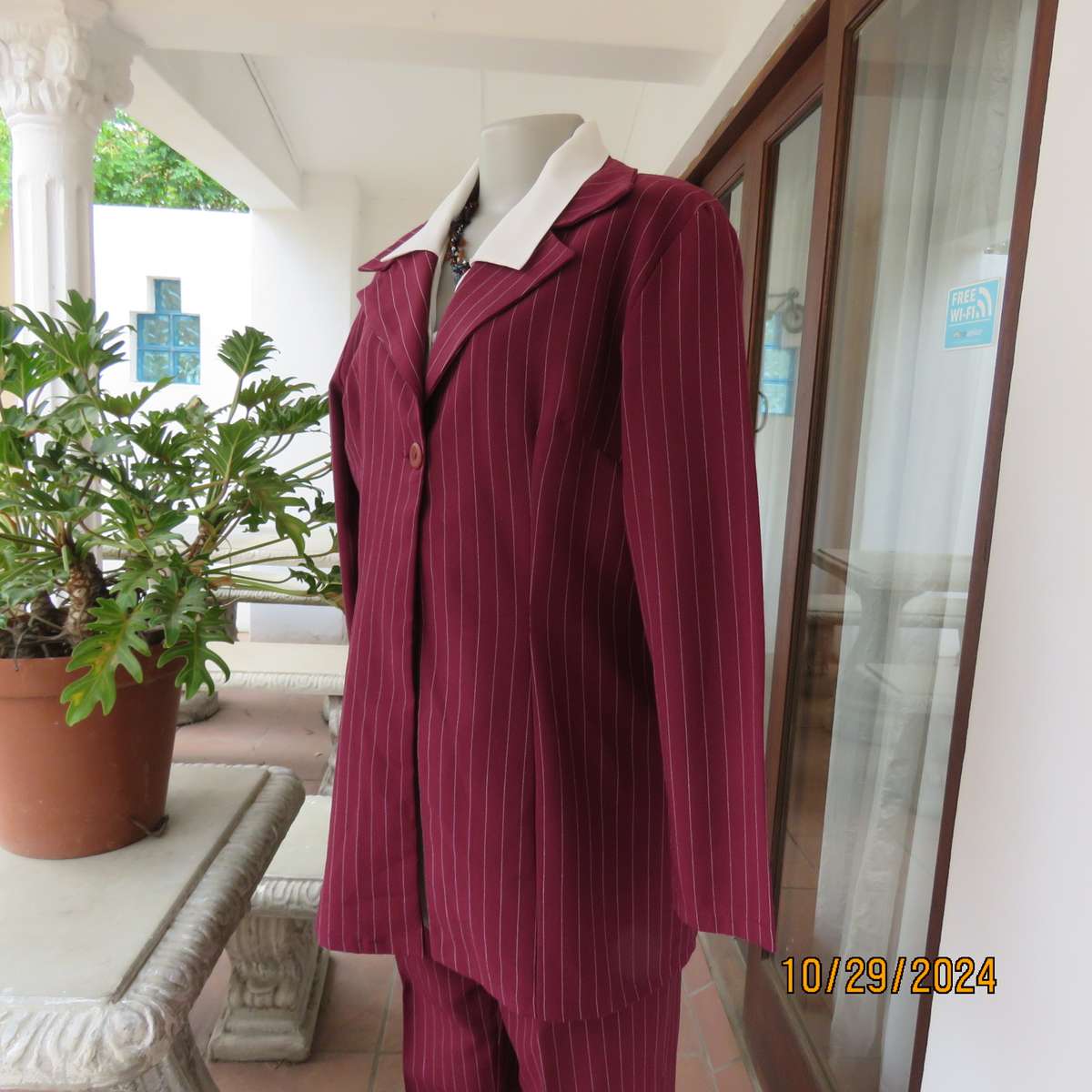 Classic maroon-white pinstripe 2 pc pantsuit. In 100% polyester. Tailored 1 button jacket. Size 40.