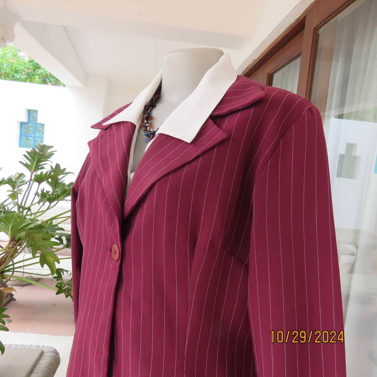 Classic maroon-white pinstripe 2 pc pantsuit. In 100% polyester. Tailored 1 button jacket. Size 40.