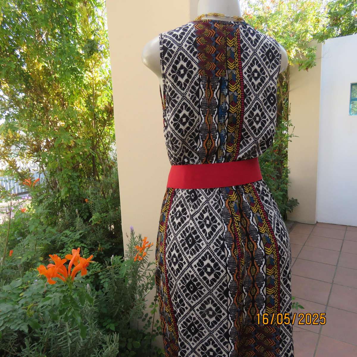 Ethnic patterned maxi polyester sleeveless dress. Elasticated waist. Size 34.