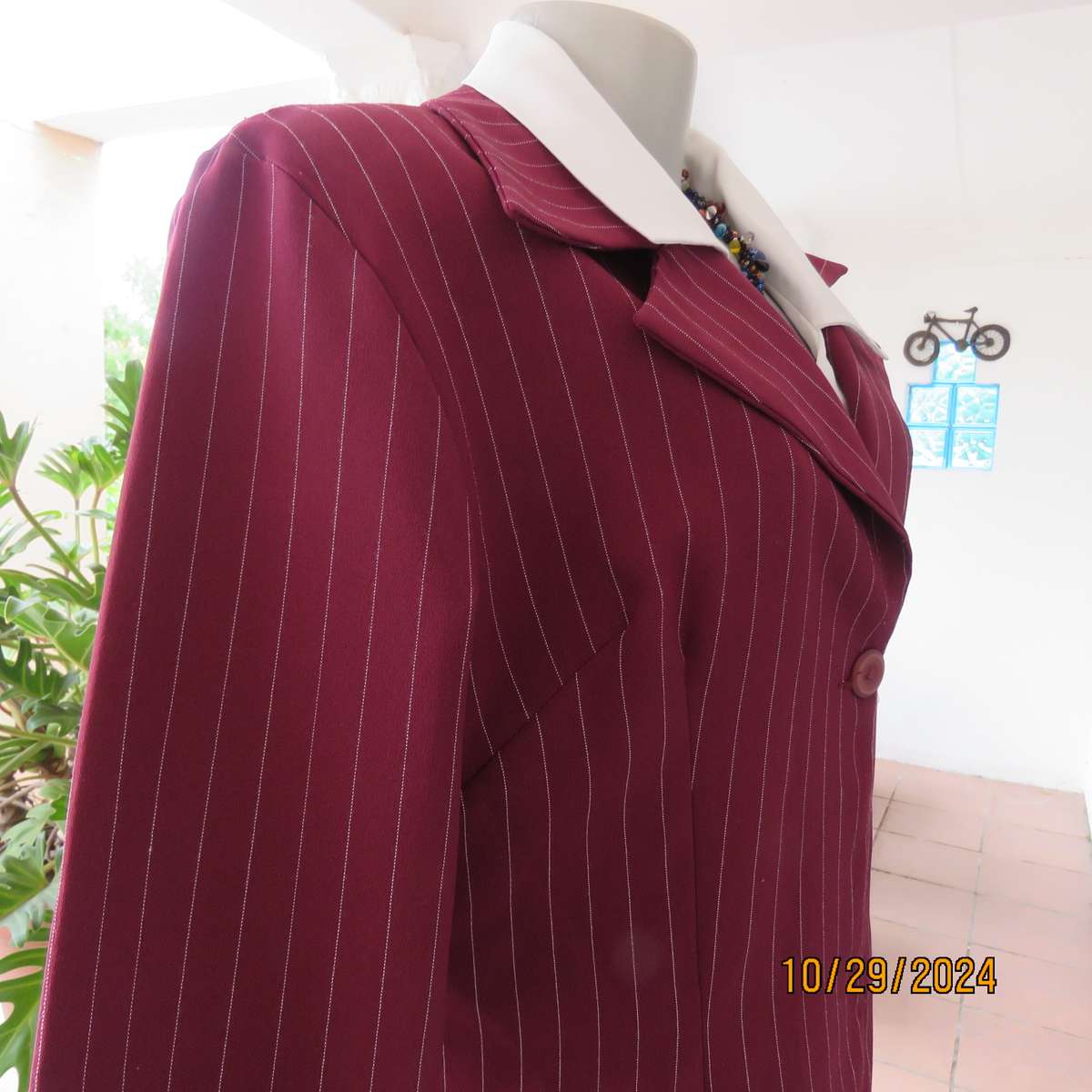 Classic maroon-white pinstripe 2 pc pantsuit. In 100% polyester. Tailored 1 button jacket. Size 40.
