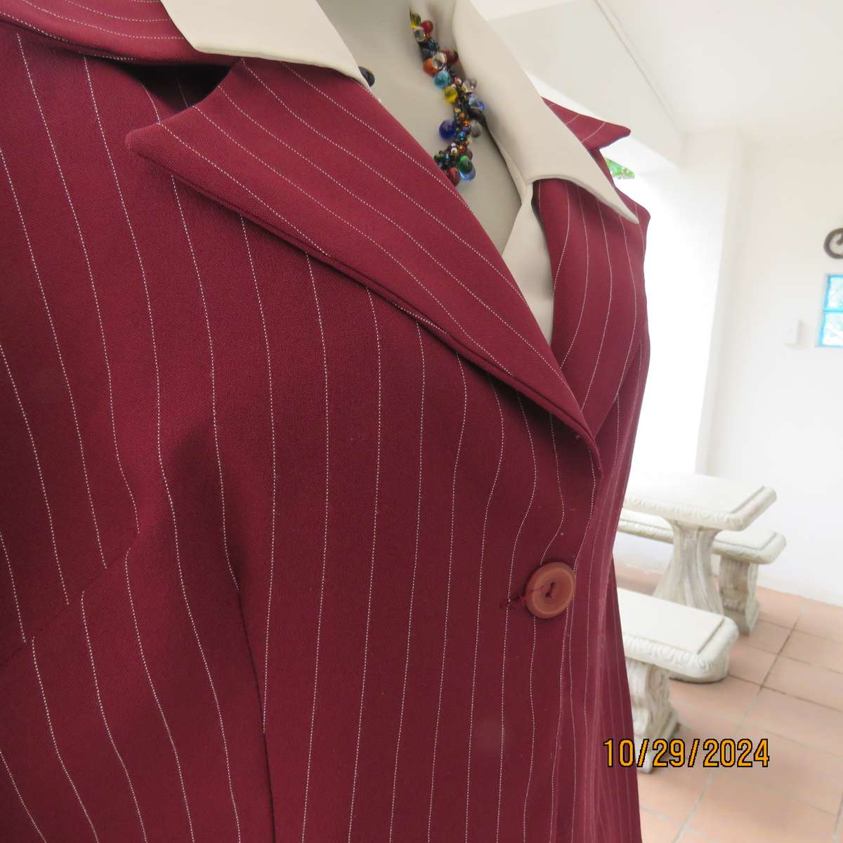 Classic maroon-white pinstripe 2 pc pantsuit. In 100% polyester. Tailored 1 button jacket. Size 40.
