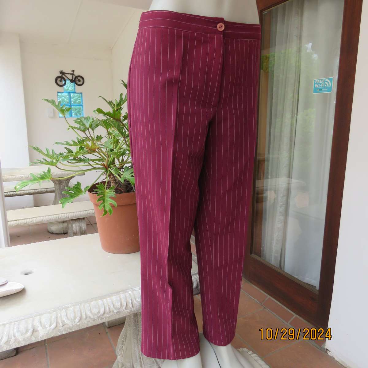 Classic maroon-white pinstripe 2 pc pantsuit. In 100% polyester. Tailored 1 button jacket. Size 40.